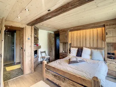 a bedroom with a bed in a wooden room at Chalet 6 pièces à Combloux avec cheminée et parking - FR-1-560-21 in Combloux