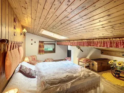 a bedroom with a bed and a wooden ceiling at Duplex cosy 35m² près du centre de Combloux, face au Mont Blanc - FR-1-560-19 in Combloux