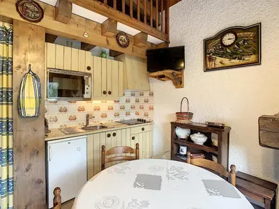 a kitchen with a white table and a sink at Duplex cosy 35m² près du centre de Combloux, face au Mont Blanc - FR-1-560-19 in Combloux