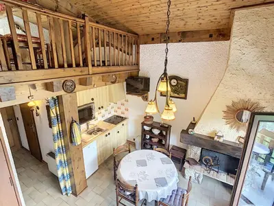 an overhead view of a kitchen with a table and chairs at Duplex cosy 35m² près du centre de Combloux, face au Mont Blanc - FR-1-560-19 in Combloux