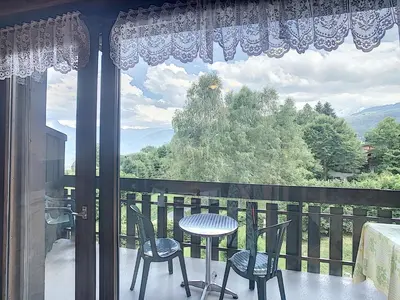 a balcony with a table and chairs and a window at Duplex cosy 35m² près du centre de Combloux, face au Mont Blanc - FR-1-560-19 in Combloux