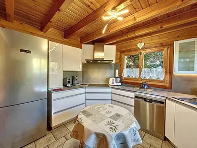 a kitchen with white cabinets and a wooden ceiling at Grand chalet confortable à Demi-Quartier, 13 couchages - FR-1-560-36 in Demi-Quartier
