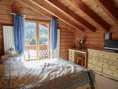 a bedroom with a bed and a window at Grand chalet confortable à Demi-Quartier, 13 couchages - FR-1-560-36 in Demi-Quartier