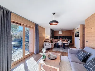 a living room with a couch and a table at Appartement 4P avec terrasse et vue Mont Blanc - FR-1-560-24 in Combloux