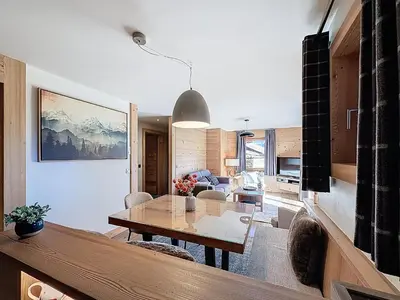 a living room with a table and a dining room at Appartement 4P avec terrasse et vue Mont Blanc - FR-1-560-24 in Combloux