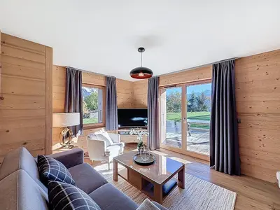 a living room with a couch and a table at Appartement 4P avec terrasse et vue Mont Blanc - FR-1-560-24 in Combloux