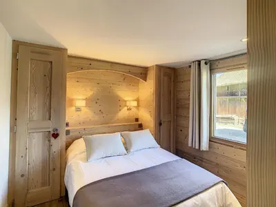 a bedroom with a bed and a window at Appartement 4P avec terrasse et vue Mont Blanc - FR-1-560-24 in Combloux