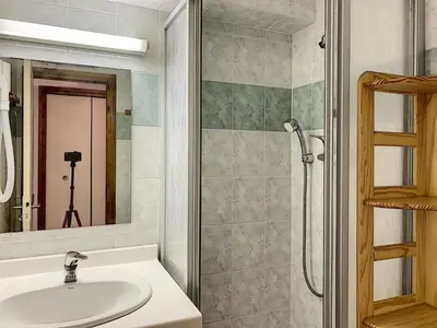 a bathroom with a sink and a shower with a mirror at Studio agréable au centre de Combloux avec parking - FR-1-560-35 in Combloux
