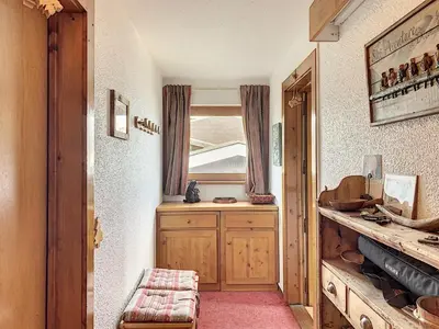a hallway with a room with a table and a window at Studio agréable au centre de Combloux avec parking - FR-1-560-35 in Combloux