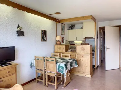 a kitchen with a table and a tv in a room at Studio agréable au centre de Combloux avec parking - FR-1-560-35 in Combloux