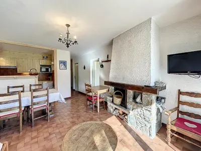 a living room with a fireplace and a dining room at Appartement 3 pièces de charme aux pieds des pistes à Combloux - FR-1-560-28 in Combloux