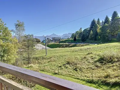 a view of a field with a fence and a road at Appartement 3 pièces de charme aux pieds des pistes à Combloux - FR-1-560-28 in Combloux