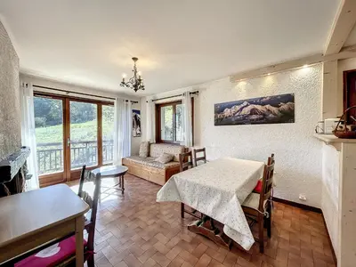 a living room with a table and a couch at Appartement 3 pièces de charme aux pieds des pistes à Combloux - FR-1-560-28 in Combloux