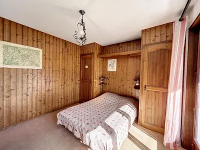 a bedroom with wooden walls and a bed in a room at Appartement 3 pièces de charme aux pieds des pistes à Combloux - FR-1-560-28 in Combloux