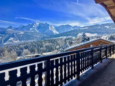 a balcony with a view of a snow covered mountain at Chalet 8 couchages à Combloux, Hiver à la saison, Été à la semaine - FR-1-560-32 in Combloux