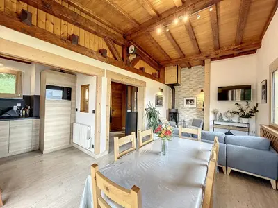 a dining room with a table and a couch at Chalet 8 couchages à Combloux, Hiver à la saison, Été à la semaine - FR-1-560-32 in Combloux
