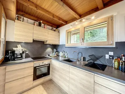 a kitchen with wooden cabinets and a sink at Chalet 8 couchages à Combloux, Hiver à la saison, Été à la semaine - FR-1-560-32 in Combloux