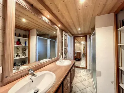 a bathroom with two sinks and a large mirror at Chalet 8 couchages à Combloux, Hiver à la saison, Été à la semaine - FR-1-560-32 in Combloux