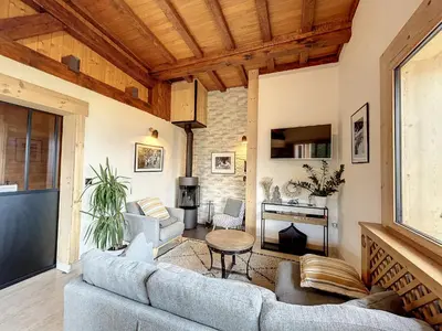 a living room with a couch and a table at Chalet 8 couchages à Combloux, Hiver à la saison, Été à la semaine - FR-1-560-32 in Combloux