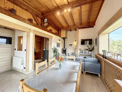 a dining room with a table and a couch at Chalet 8 couchages à Combloux, Hiver à la saison, Été à la semaine - FR-1-560-32 in Combloux