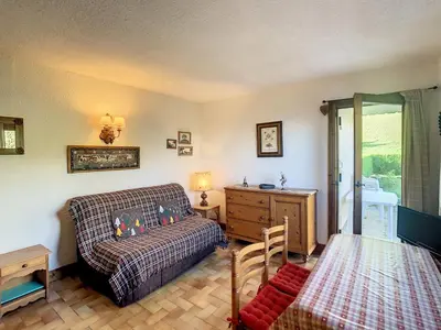 a living room with a couch and a table at Studio cabine cosy proche du téléski - FR-1-560-40 in Combloux