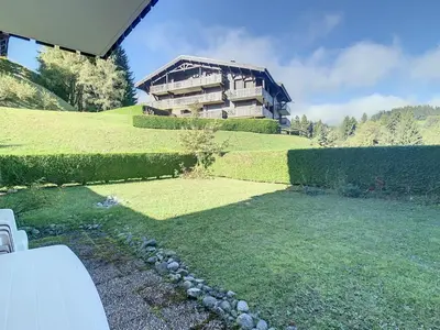 a large house on top of a green hill at Studio cabine cosy proche du téléski - FR-1-560-40 in Combloux