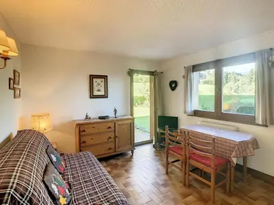 a bedroom with a bed and a table and a desk at Studio cabine cosy proche du téléski - FR-1-560-40 in Combloux