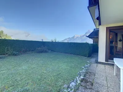 a yard next to a house with a fence at Studio cabine cosy proche du téléski - FR-1-560-40 in Combloux