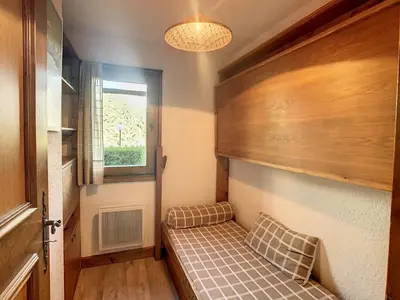 a small room with a bed and a window at Studio cabine cosy proche du téléski - FR-1-560-40 in Combloux