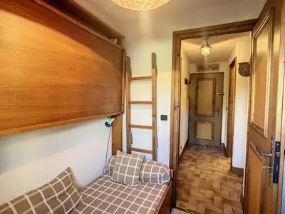a hallway with a couch in a room at Studio cabine cosy proche du téléski - FR-1-560-40 in Combloux