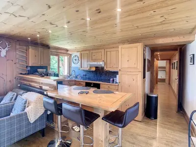 a kitchen and living room with a table and a couch at 3 pièces, piscine intérieure, parking, proche centre à Combloux - FR-1-560-27 in Combloux
