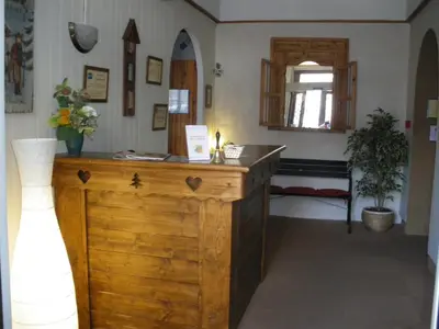 a room with a wooden counter and a mirror at Hotel du Mont Blanc in Sallanches