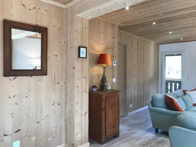 a living room with a blue couch and a mirror at La Maison du Hérisson in Samoëns