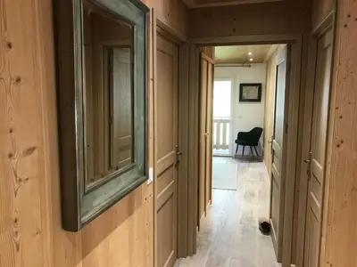 a hallway of a house with a mirror on the wall at La Maison du Hérisson in Samoëns