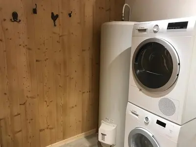 a washing machine and a dryer in a room at La Maison du Hérisson in Samoëns