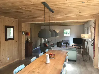 a living room with a wooden table and a couch at La Maison du Hérisson in Samoëns