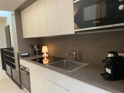 a kitchen with a sink and a microwave at Chalet Pleine Vue & Spa in Chamonix-Mont-Blanc