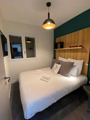 a bedroom with a large white bed with two towels on it at Chalet Pleine Vue & Spa in Chamonix-Mont-Blanc