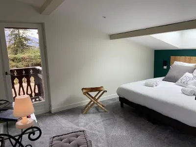 a bedroom with a bed and a window at Chalet Pleine Vue & Spa in Chamonix-Mont-Blanc