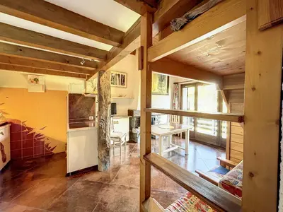 a kitchen with wooden ceilings and a table at Duplex cosy au pied des pistes de Combloux - FR-1-560-47 in Combloux