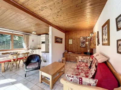 a living room with a couch and a table at Bel Apt au Centre de Combloux avec Jardin, Balcon, Wifi et Parking à 300m des Commerces - FR-1-560-52 in Combloux