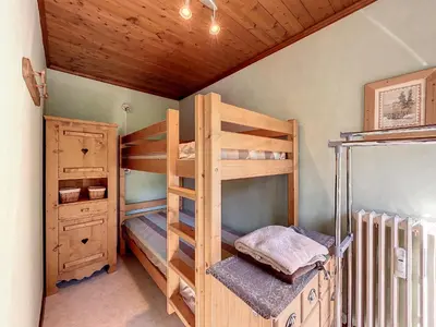 a bedroom with two bunk beds in a house at Bel Apt au Centre de Combloux avec Jardin, Balcon, Wifi et Parking à 300m des Commerces - FR-1-560-52 in Combloux