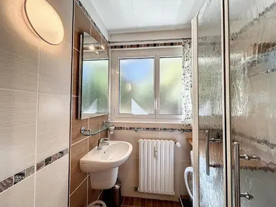 a small bathroom with a sink and a window at Bel Apt au Centre de Combloux avec Jardin, Balcon, Wifi et Parking à 300m des Commerces - FR-1-560-52 in Combloux