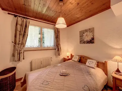 a bedroom with a large bed in a room at Bel Apt au Centre de Combloux avec Jardin, Balcon, Wifi et Parking à 300m des Commerces - FR-1-560-52 in Combloux