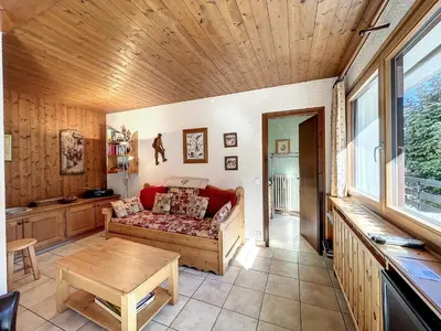 a living room with a couch and a table at Bel Apt au Centre de Combloux avec Jardin, Balcon, Wifi et Parking à 300m des Commerces - FR-1-560-52 in Combloux