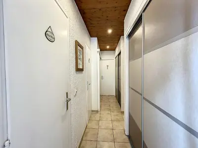 a hallway with a door and a tile floor at Bel Apt au Centre de Combloux avec Jardin, Balcon, Wifi et Parking à 300m des Commerces - FR-1-560-52 in Combloux