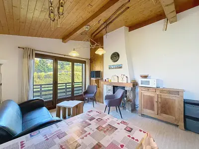 a living room with a couch and a table at Charmant 3 pièces au pied des pistes à Combloux - FR-1-560-59 in Combloux