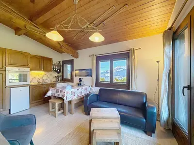 a living room with a couch and a table at Charmant 3 pièces au pied des pistes à Combloux - FR-1-560-59 in Combloux
