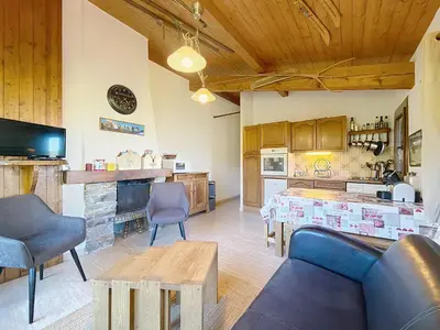 a living room with a couch and a table at Charmant 3 pièces au pied des pistes à Combloux - FR-1-560-59 in Combloux