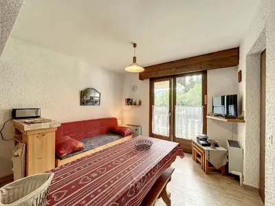 a living room with a red couch in a room at Appartement cosy au pied des pistes à Combloux avec balcon et casier à skis - FR-1-560-61 in Combloux